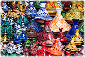 Diese Töpfe werden Tajine genannt. Das darin zubereitete Essen hört auf den gleichen Namen. Ein paar bunte und auffällige Tajin-Töpfe in unterschiedlichen Farben.